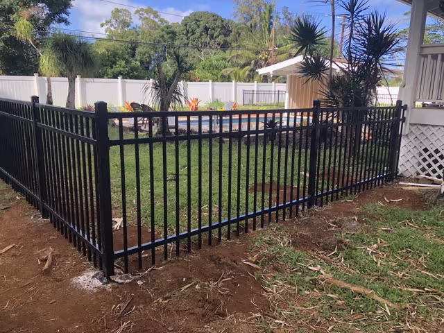 6-foot cedar privacy fence with custom gate in Lihue.